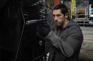 Scott Adkins holding black pistol wearing gray coat HD wallpaper